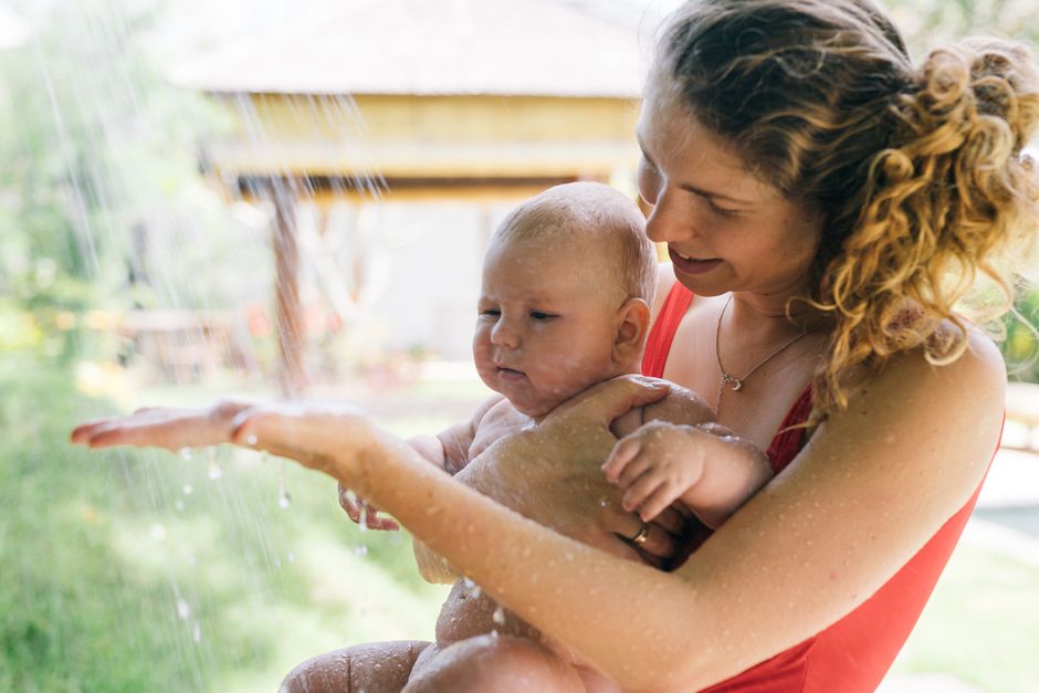 A joyful moment between a mother and child under a summer splash, capturing love and happi