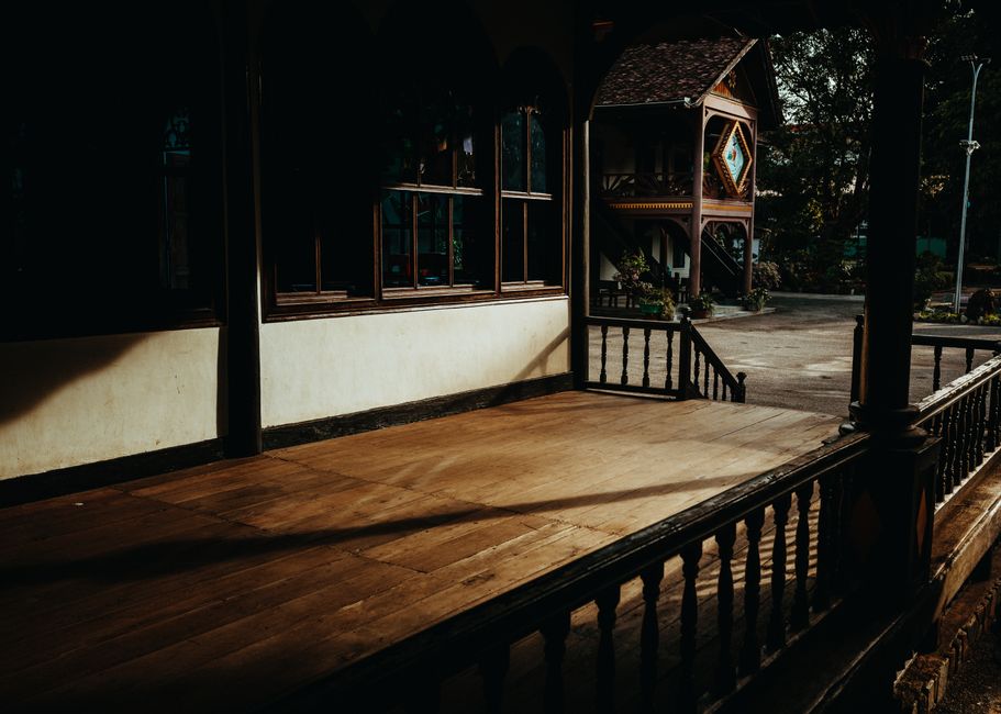Capture of a traditional wooden house in Kon Tum, Vietnam, with warm natural lighting.