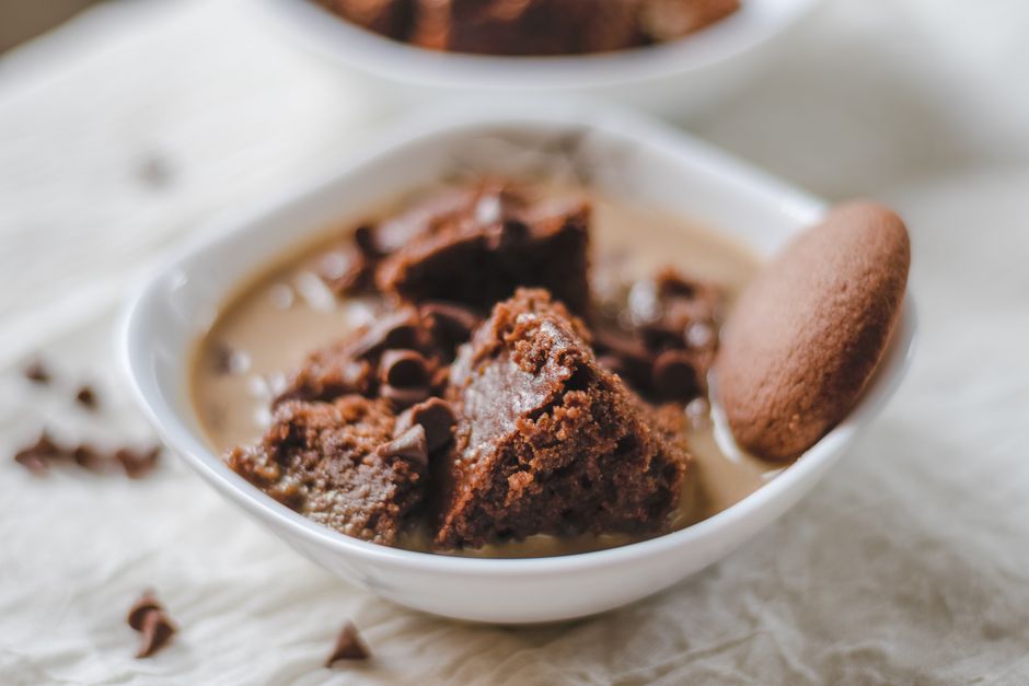 Close-up of a rich chocolate dessert served in a white ceramic bowl with a hint of indulge