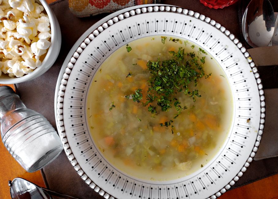 Delicious vegetable soup served with fresh cilantro, perfect for a cozy meal.