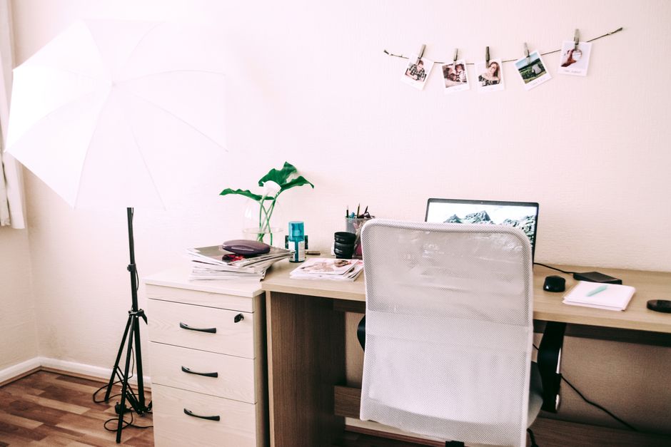 Stylish home office setup with a laptop, desk, and decorative accents, perfect for remote 