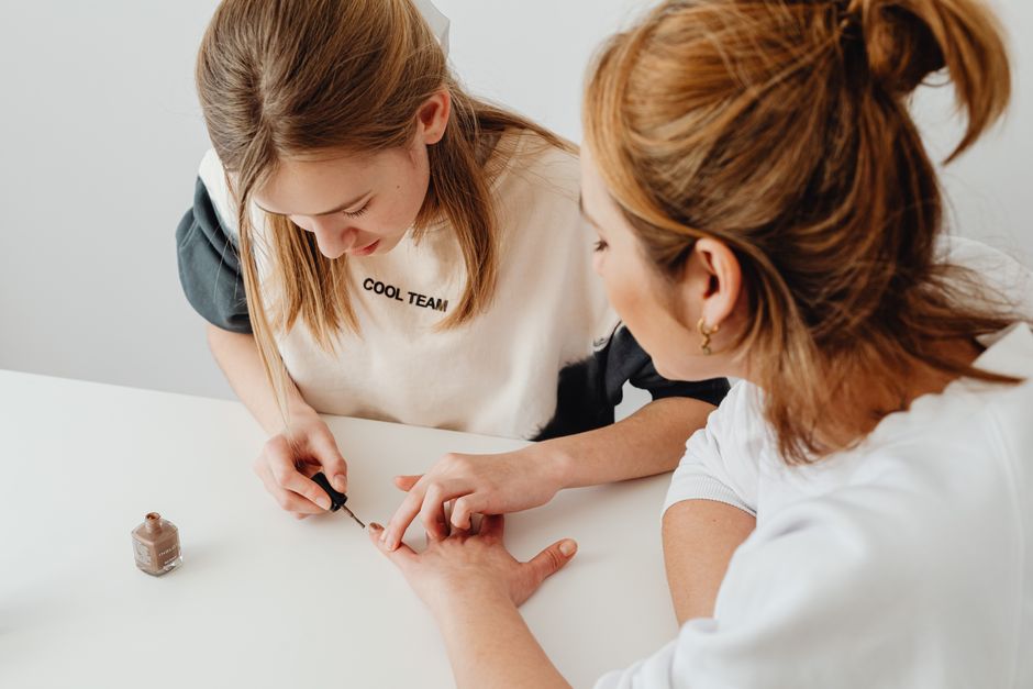 Woman painting her nails at home